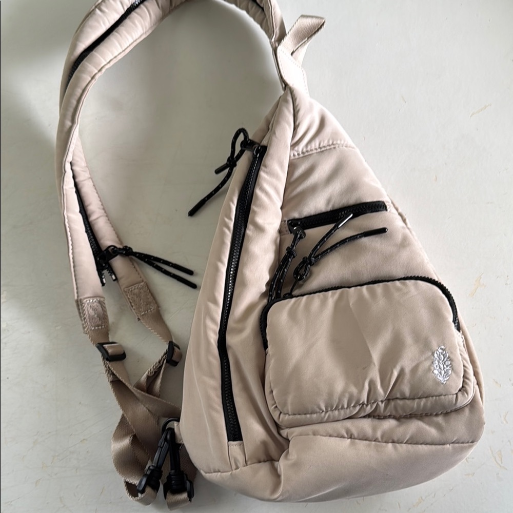 Beige Sling Backpack with Black Accents